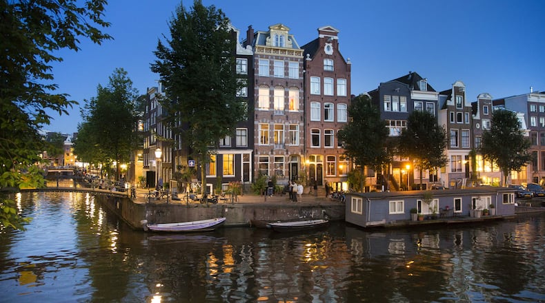 Houses line the canals of Amsterdam’s city center, Aug. 23, 2016. Amsterdam is growing and going through dramatic changes as large numbers of young people, both native-born and immigrant, put down roots and reshape the urban landscape. But in the heart of the city, the canal zone, it is always the Dutch Golden Age. (Ilvy Njiokiktjien/The New York Times)