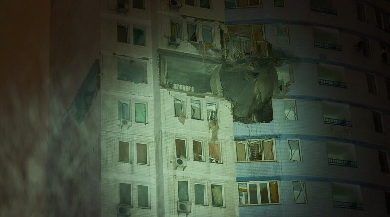 A residential building is damaged after a Russian air strike during a heavy snow storm in Kyiv, Ukraine, early Friday, Jan. 9, 2026. (AP Photo/Efrem Lukatsky)