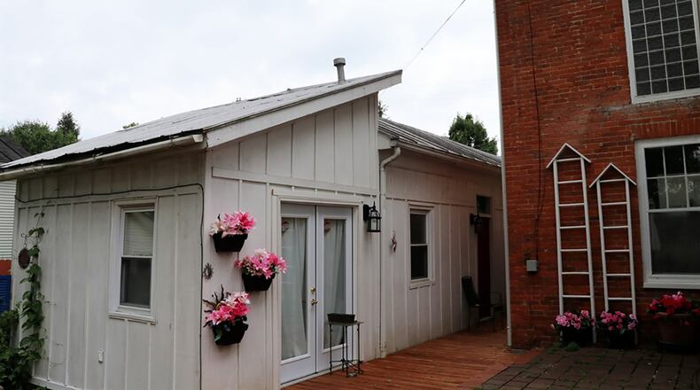 The 3-car, detached garage has a studio apartment, and the fenced back yard has a wooden deck, paver patio and gardens.