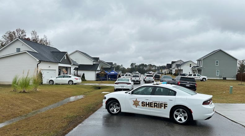 Law enforcement vehicles block the road to Wellington Delano Dickens III's home, where remains were found after Dickens told authorities he had killed four of his children, in Zebulon, N.C., on Tuesday, Oct. 28, 2025. (AP Photo/Allen G. Breed)