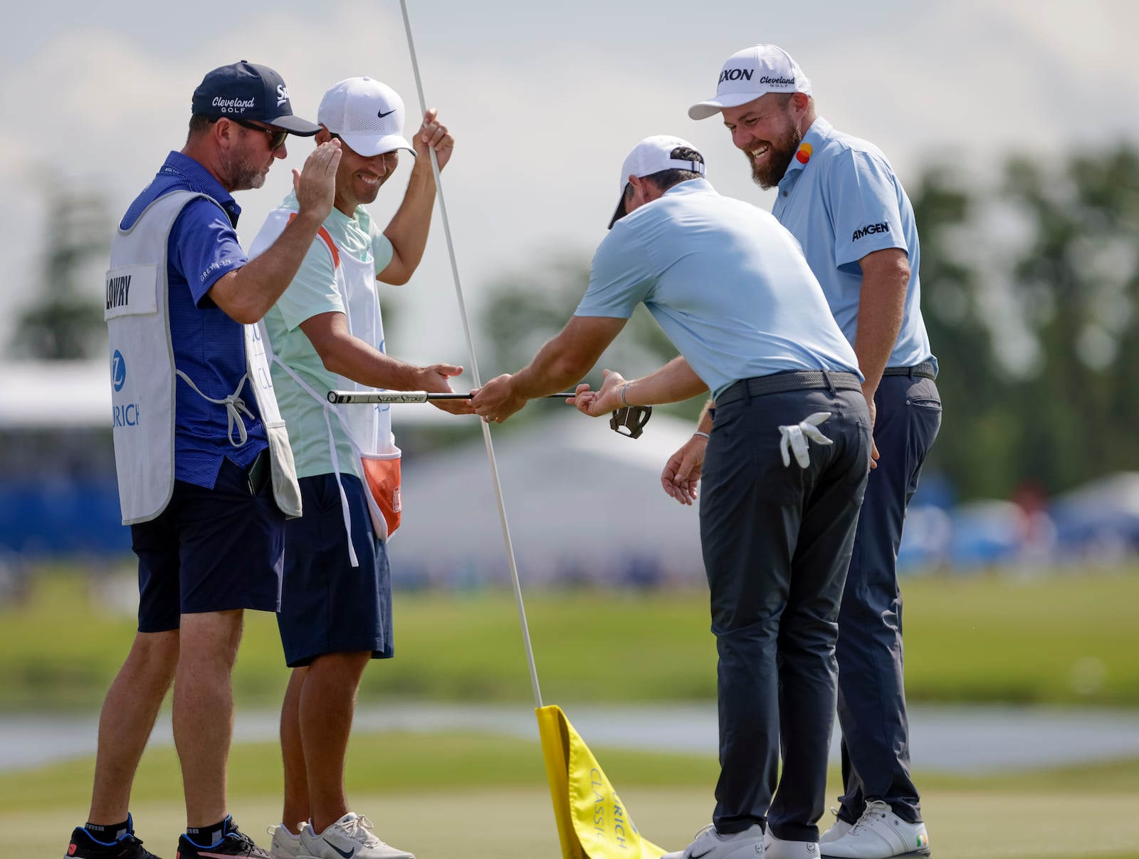 Masters champion Rory McIlroy presents his putter to his caddy after he knocked in an eagle putt on the 18th hole during the Zurich Classic at TPC Louisiana in Avondale, Saturday, April 26, 2025. (Scott Threlkeld/The New Orleans Advocate via AP)