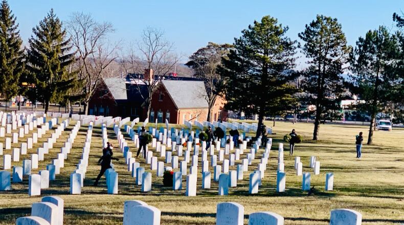 More than 50 volunteers from Wright-Patterson Air Force Base, the Cub Scouts and other Miami Valley civic organizations take part in a wreath-collection effort Jan. 23 at Dayton National Cemetery. The group picked up more than 5,000 from veteran gravesites that had been placed in November as part of Wreaths Across America. CONTRIBUTED PHOTO