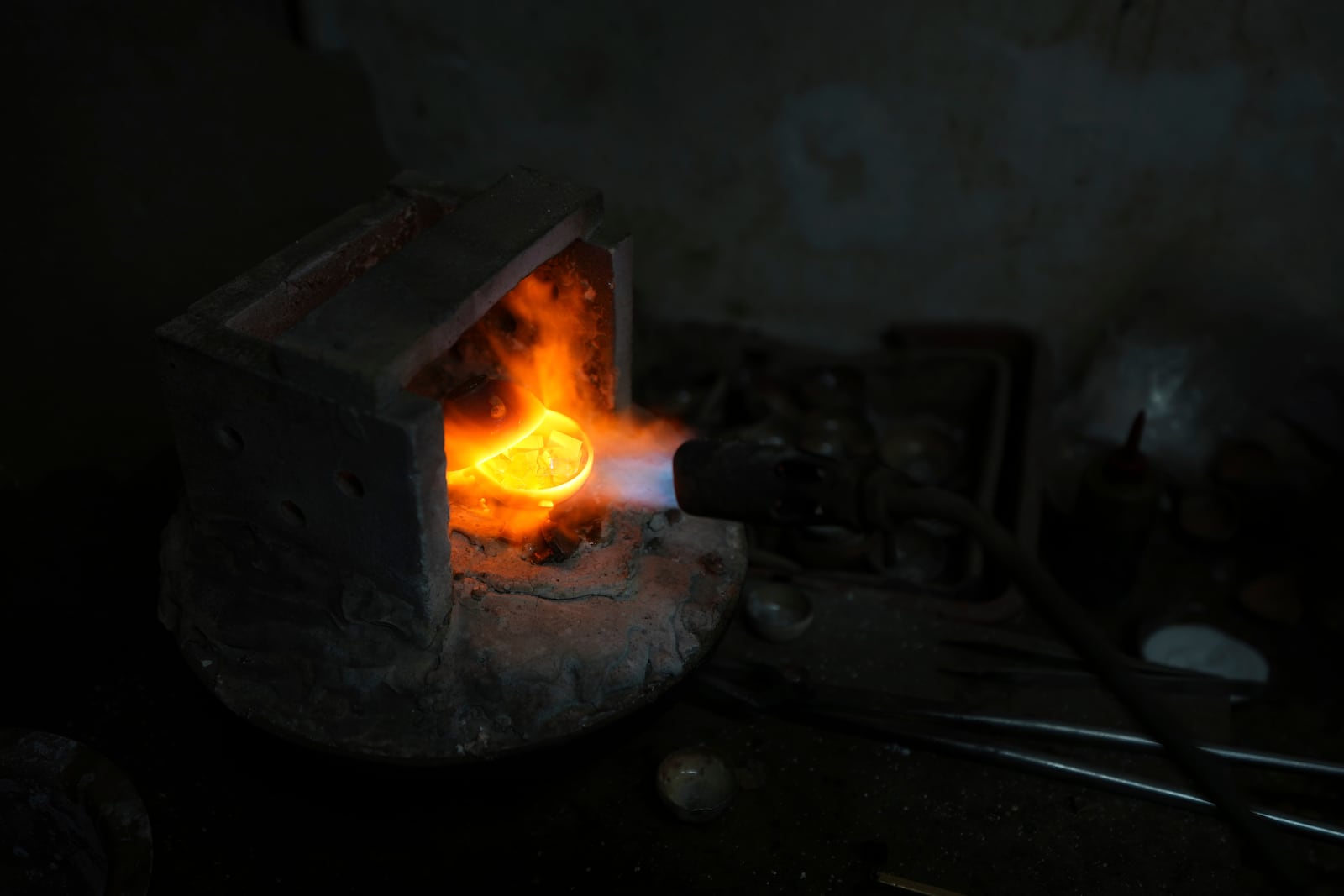 A goldsmith melts gold in Ahmedabad, India, Tuesday, April 8, 2025. (AP Photo/Ajit Solanki)