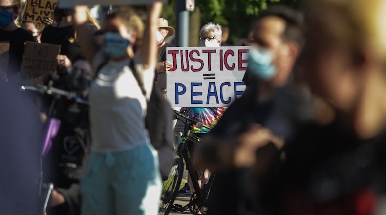 Hundreds of protesters gathered in front of Wright Library in Oakwood Thursday evening. Jim Noelker/Staff