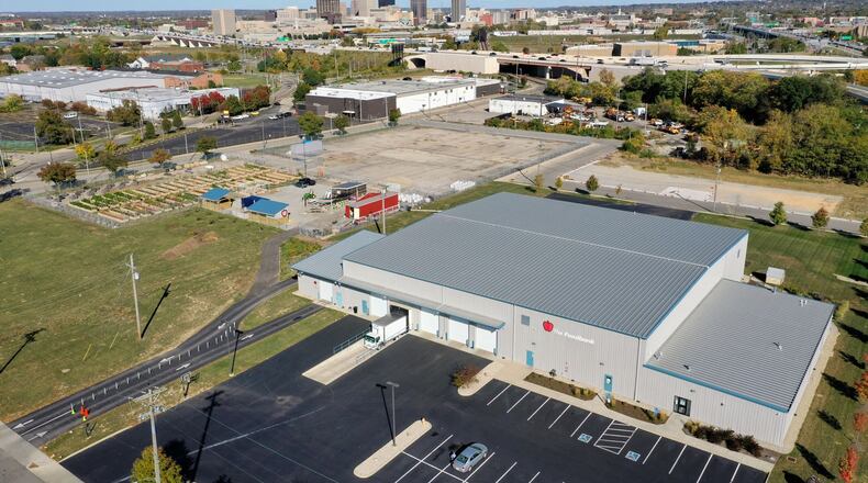 The Foodbank’s site (left) has made a lot of out of a former industrial site (a “before” image shown at right), transforming it into a space with vegetable gardens, trees and even pollinator habitat (as seen in the background of the left photo). CONTRIBUTED