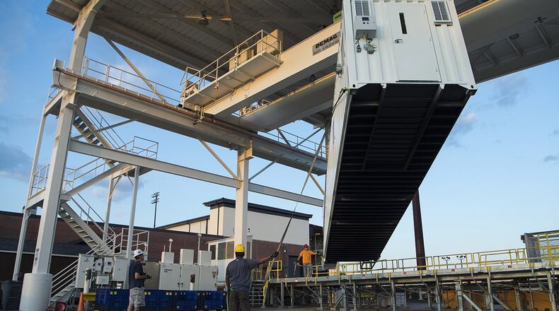 Civilians from the 437th Aerial Port Squadron position a Negatively Pressurized Conex prototype after its delivery to Joint Base Charleston, S.C., April 21, 2020. The NPC was rapidly developed and designed to fit inside both C-5 and C-17 aircraft to enable safe transport of up to 28 patients, as well as teams of medical professionals to medical facilities around the globe. (U.S. Air Force photos/Staff Sgt. Chris Drzazgowski)