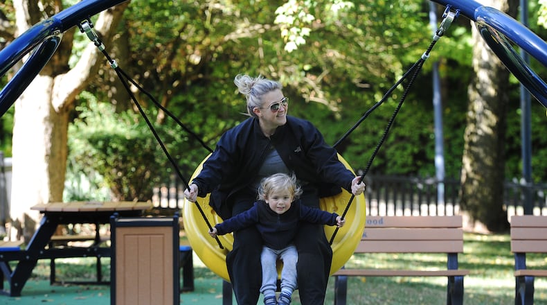 Kate Griffiths with her son, Murphy, 2, enjoy Friday morning together swinging at Cook Park in Oakwood. MARSHALL GORBY\STAFF