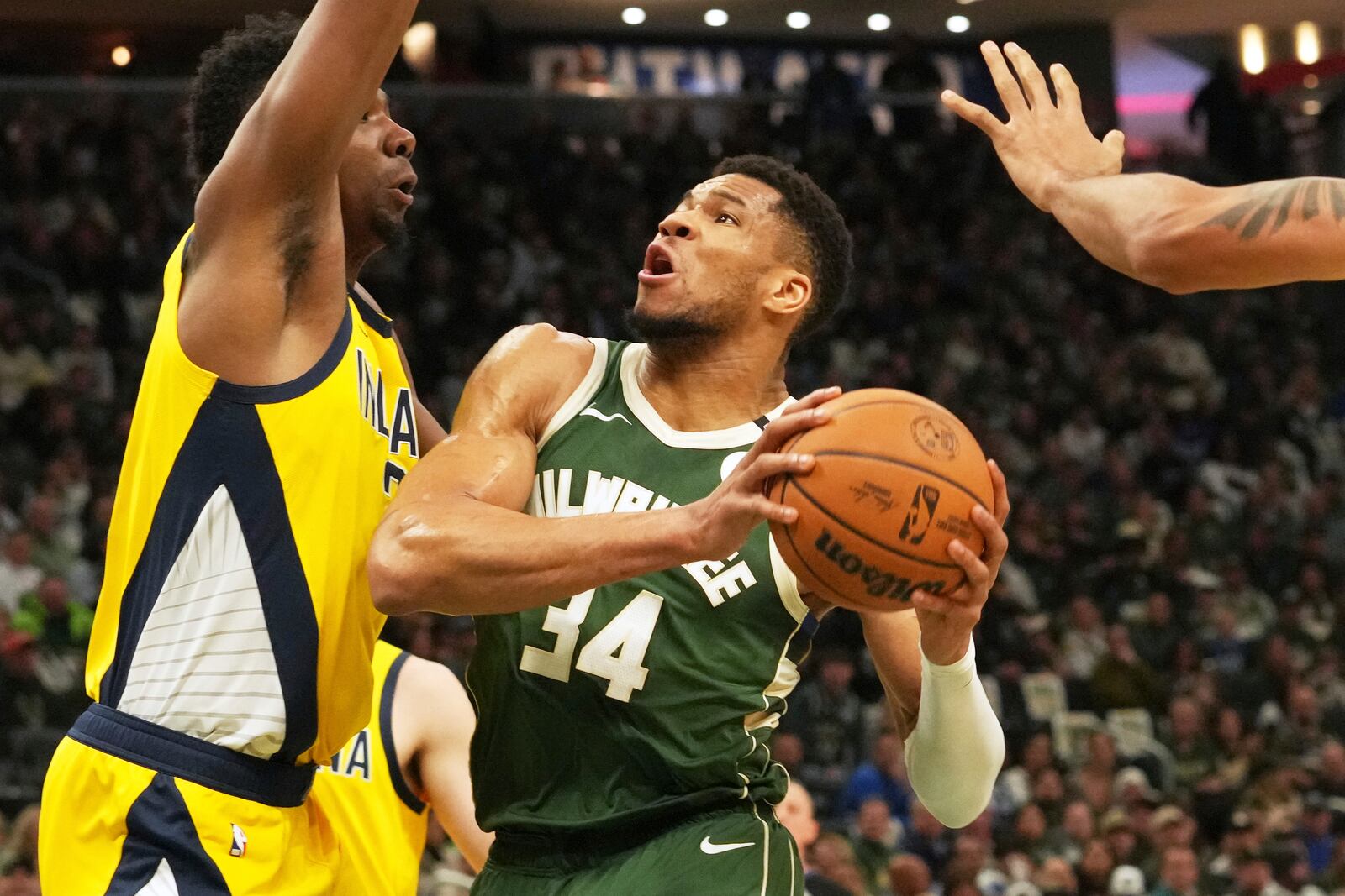 Milwaukee Bucks forward Giannis Antetokounmpo, right, drives against Indiana Pacers center Thomas Bryant, left, during the first half in Game 3 of an NBA basketball first-round playoff series Friday, April 25, 2025, in Milwaukee. (AP Photo/Nam Y. Huh)