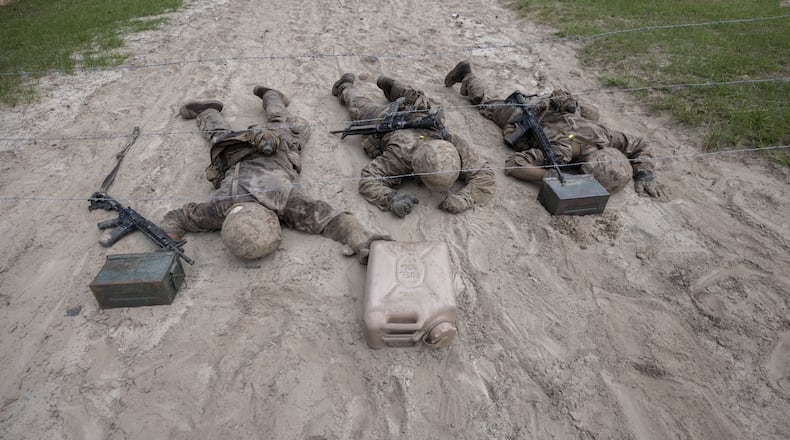 Three U.S. Marine Corps male recruits negotiate an obstacle during during a portion of training known as the Crucible at the Marine Corps Recruit Depot, Thursday, June 29, 2023, in Parris Island, S.C. (AP Photo/Stephen B. Morton)