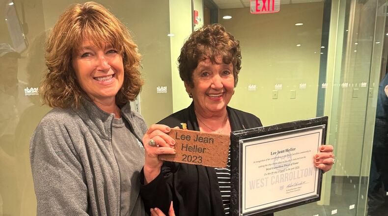 Lee Jean Heller (right) and her daughter, Stacey Swank, emerge from a West Carrollton City Council meeting after Heller was inducted into the West Carrollton Plaza of Fame Tuesday, April 9, 2024. The annual award recognizes current or former residents for making the city a better place to live and work. CONTRIBUTED