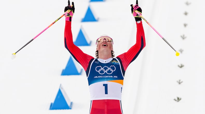 Johannes Hoesflot Klaebo, of Norway, crosses the finish line to win the gold medal during the cross country skiing men's 50km mass start Classic at the 2026 Winter Olympics, in Tesero, Italy, Saturday, Feb. 21, 2026. (AP Photo/Kirsty Wigglesworth)