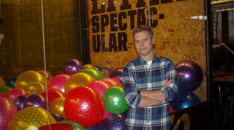 Founder and owner of the Proto BuildBar and Creator Director of Real Art standing next to the world’s largest Claw Game is Chris Wire. The claw game can be found and played at the Proto BuildBar.