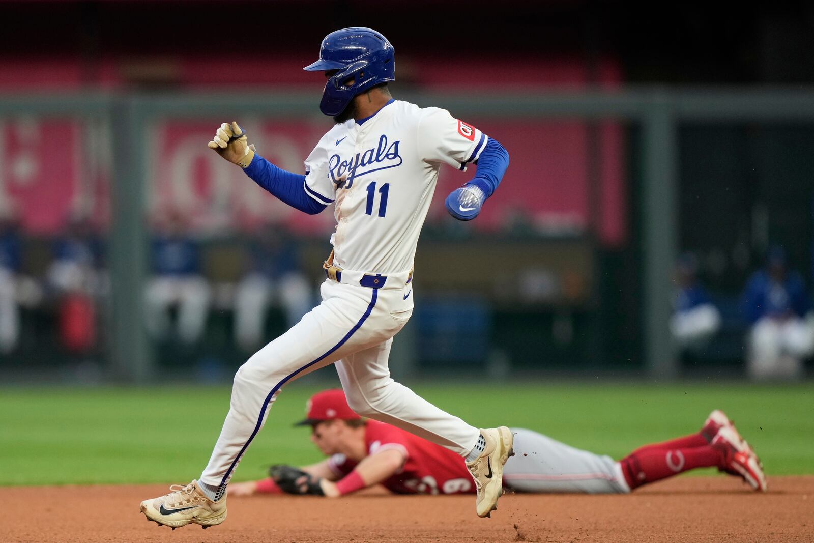 Kansas City Royals' Maikel Garcia runs past Cincinnati Reds second baseman Matt McLain to score on a single by Drew Waters during the fourth inning of a baseball game Wednesday, May 28, 2025, in Kansas City, Mo. (AP Photo/Charlie Riedel)