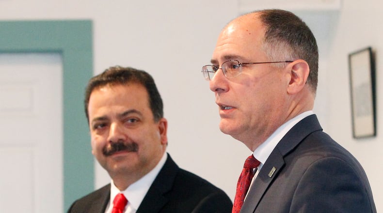 Premier Health and the University of Dayton are partnering to create a center devoted to cybersecurity. In this recent file photo, Premier Health President Mark Shaker, left, listens to UD President Eric Spina. TY GREENLEES / STAFF