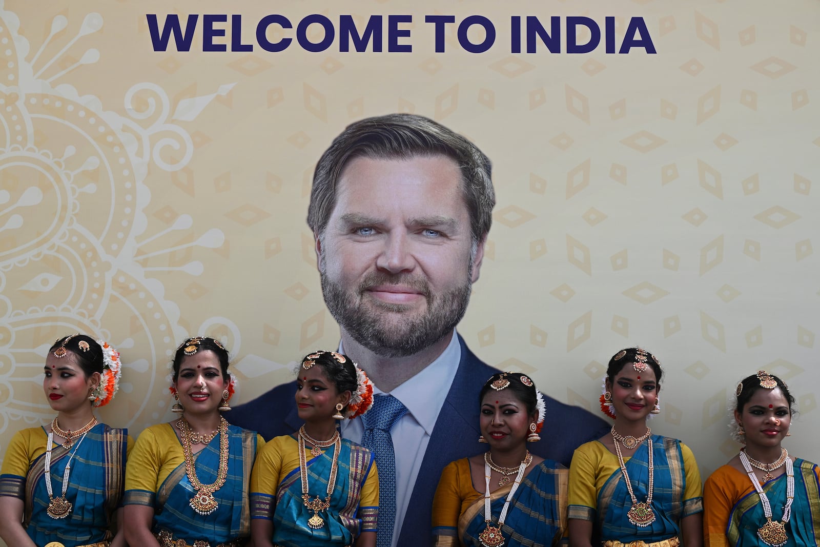 A poster of U.S. Vice President JD Vance is displayed as he arrives in New Delhi, India, Monday, April 21, 2025. (Kenny Holston/The New York Times via AP, Pool)