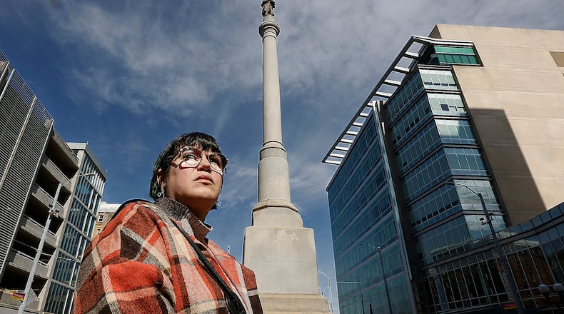 Carly Risenhoover-Peterson at the Civil War monument at Main and Monument in downtown Dayton. MARSHALL GORBY\STAFF