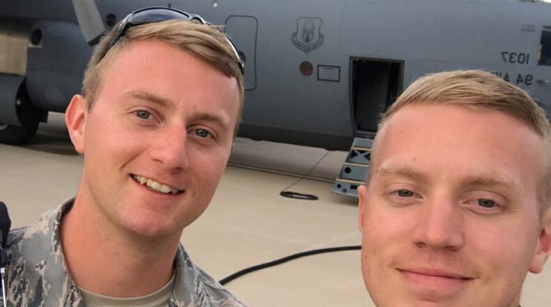 Tech. Sgt. Joel Putnam (left), a 94th Aircraft Maintenance Squadron crew chief, and his brother, Staff Sgt. Jeremy Putnam, a 94th Maintenance Squadron aerospace propulsion technician, pose for a photo in front of a C-130H3 Hercules at Dobbins Air Reserve Base, Ga. (U.S. Air Force photo/Senior Airman Justin Clayvon)