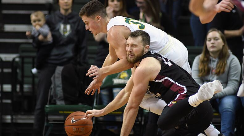 Wright State’s Cole Gentry battles IUPUI’s Evan Hall for a loose ball during the Raiders’ win against the Jaguars earlier this season. KEITH COLE/CONTRIBUTED PHOTO