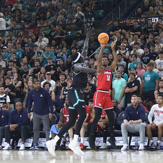 Dayton's Bryce Heard shoots against North Carolina Wilmington in the first round of the National Invitation Tournament on Saturday, March 21, 2026, at Trask Coliseum in Wilmington, N.C.. David Jablonski/Staff