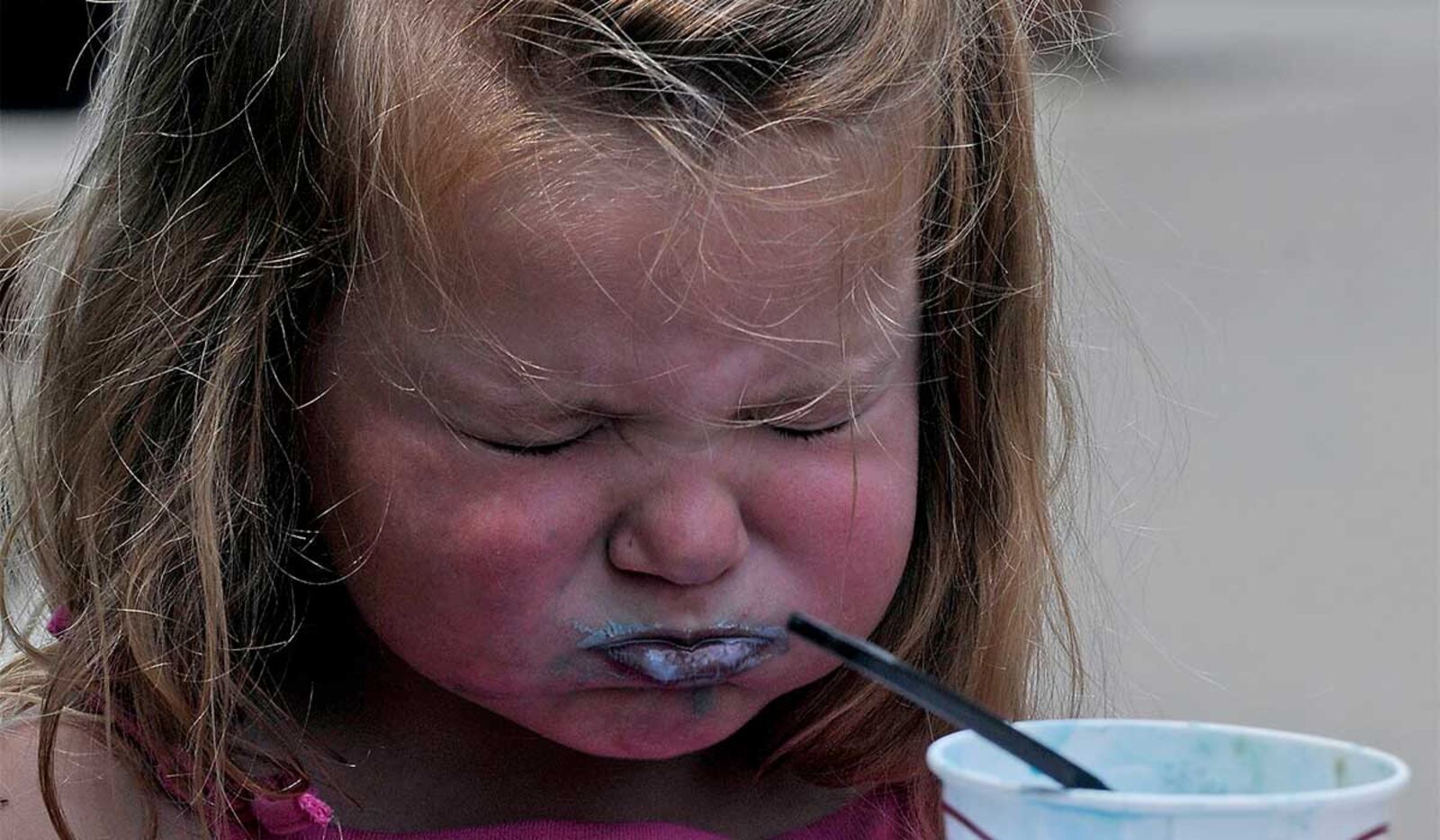 Rylee Sallee gets a brain freeze while having ice cream at Young's Jersey Dairy. Staff photo by Marshall Gorby