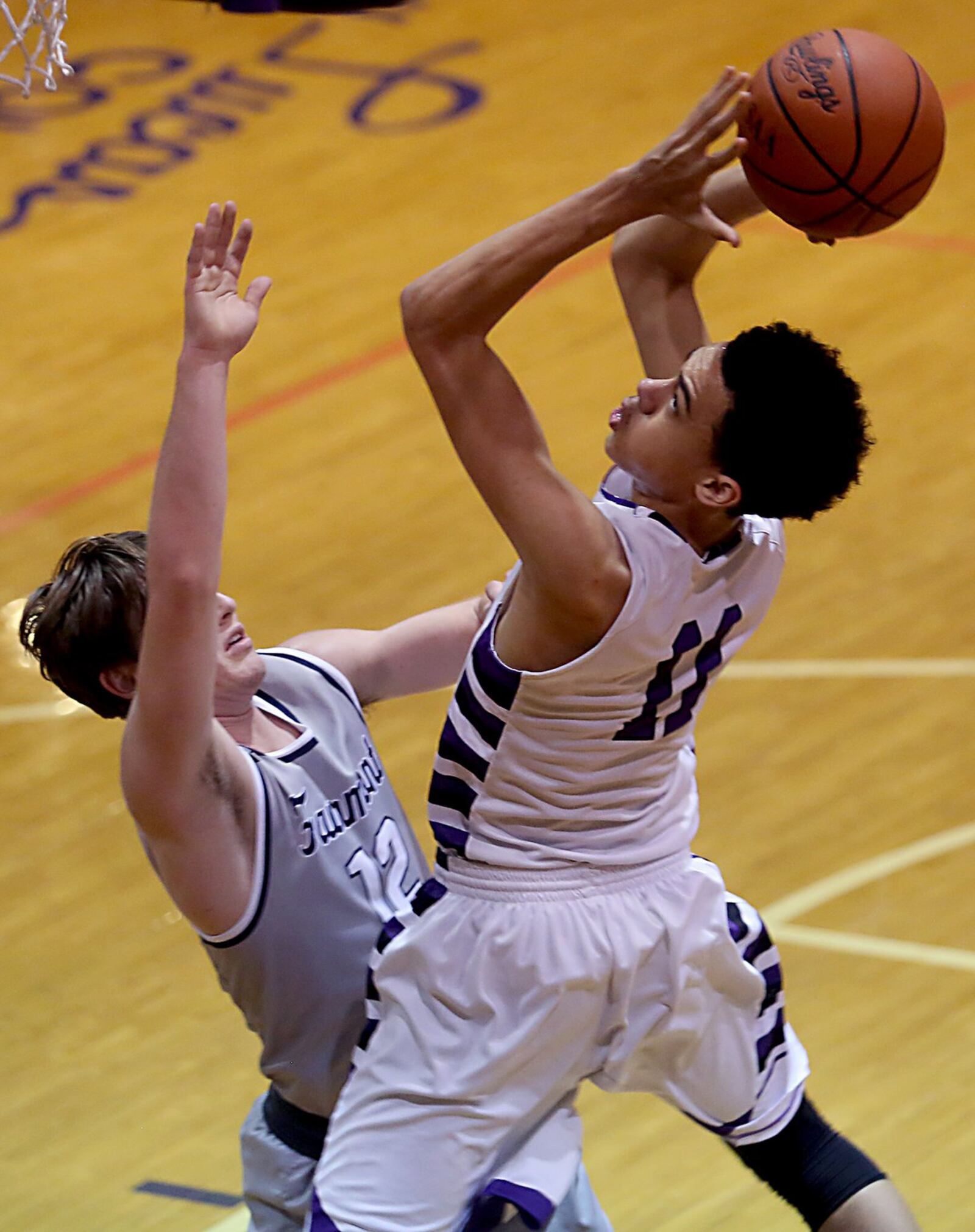 Middletown guard Cliff Snow shoots against Fairmont guard Jansen Davidson on Wednesday night at Wade E. Miller Gym in Middletown. CONTRIBUTED PHOTO BY E.L. HUBBARD