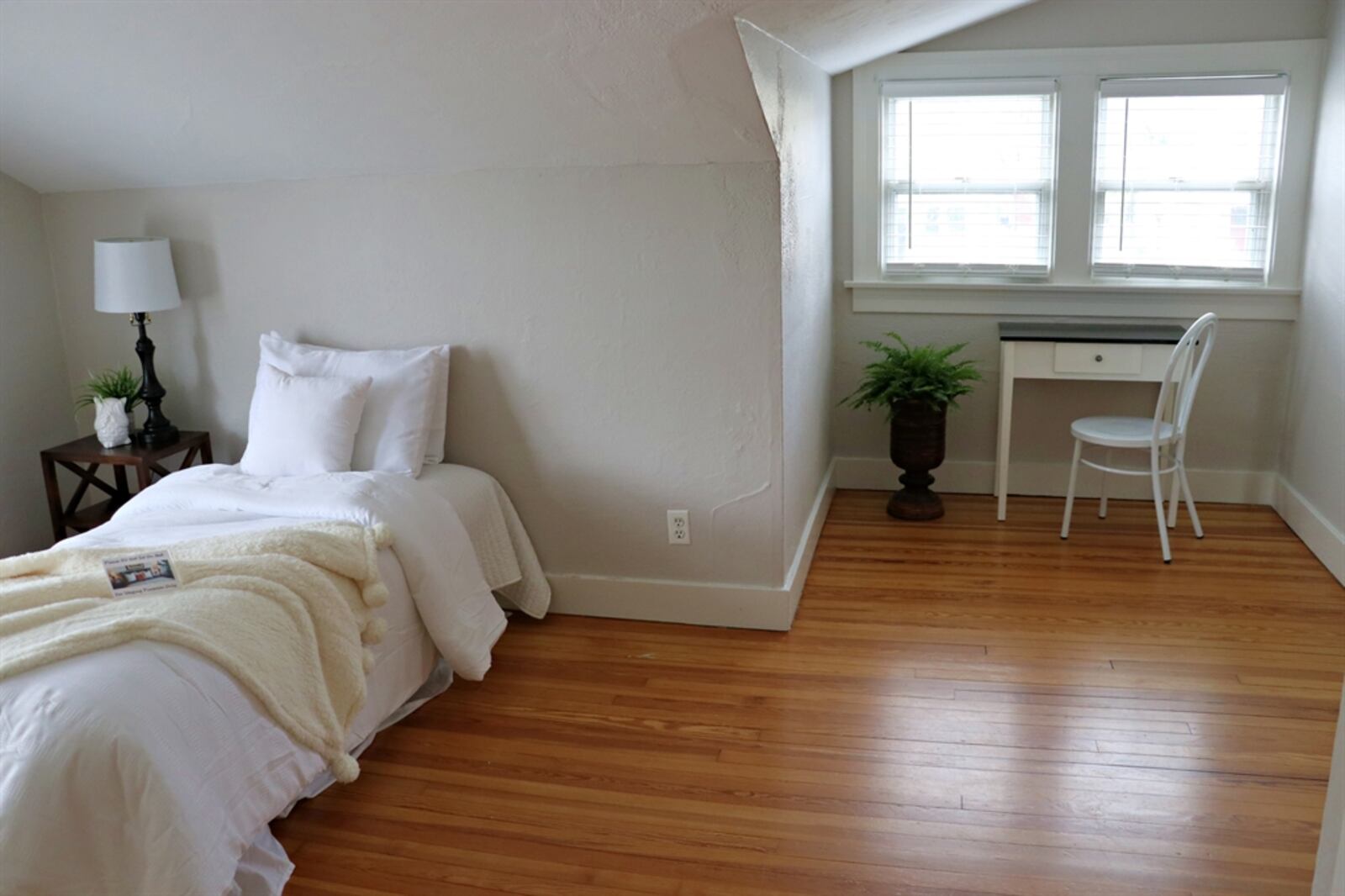 This bedroom has a sitting area near the windows and two closets. 