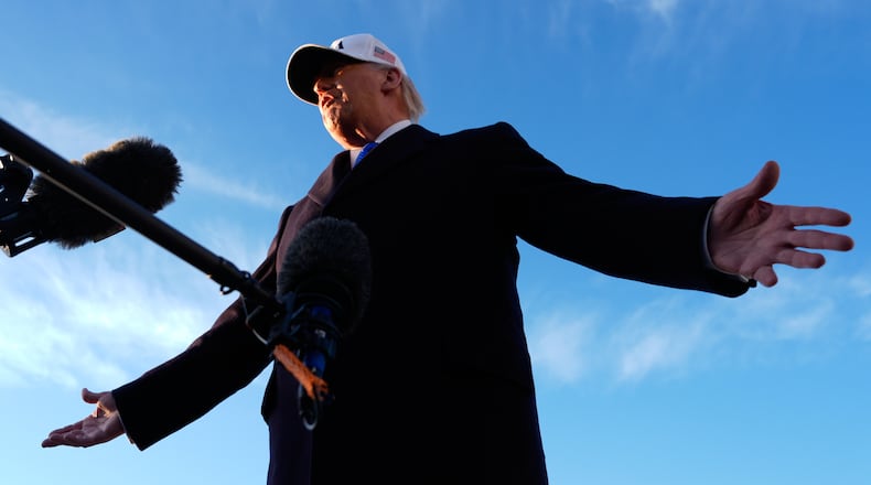 President Donald Trump speaks to reporters before he boards Air Force One, Friday, March 13, 2026, at Joint Base Andrews, Md., for a trip to Florida. (AP Photo/Mark Schiefelbein)