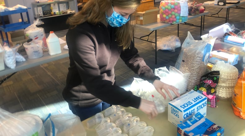 The Boonshoft Museum of Discovery closed to the public on May 15. Education Coordinator Alyssa McKinney helps assemble Camp in a Box kits.