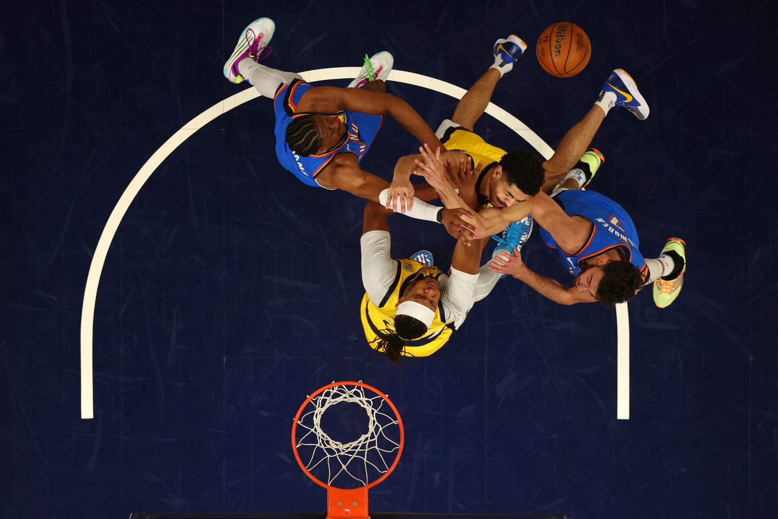 Oklahoma City Thunder forward Chet Holmgren, right, and forward Dillon Jones, left, battle for the ball against Indiana Pacers guard Ben Sheppard (26) and center Myles Turner during the first half of Game 3 of the NBA Finals basketball series, Wednesday, June 11, 2025, in Indianapolis. (Maddie Meyer/Pool Photo via AP)