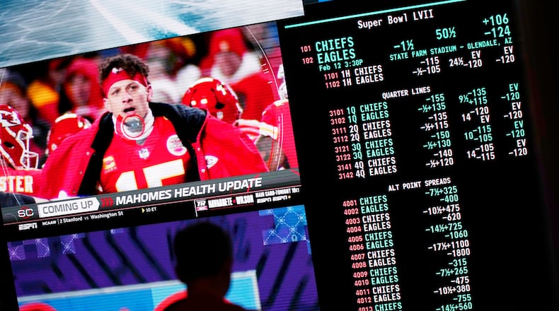 FILE PHOTO: A person gambles as betting odds for NFL football's Super Bowl are displayed on monitors at the Circa resort and casino sports book Friday, Feb. 3, 2023, in Las Vegas. (AP Photo/John Locher)