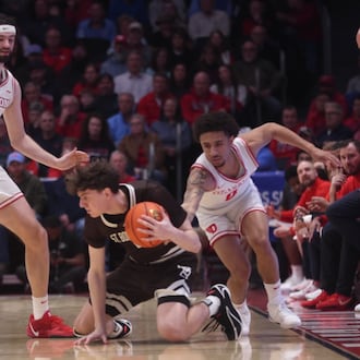 Dayton's Jacob Conner, left, and Javon Bennett, right, defend against St. Bonaventure on Tuesday, Feb. 3, 2026, at UD Arena. David Jablonski/Staff