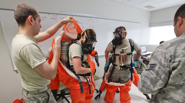Students at the U.S. Air Force School of Aerospace Medicine practice hazardous materials scenarios in the apprentice program in this 2019 photo. This class included national guard, and active duty personnel. L-R A1C Jane Vierzen and A1C James Mainolfi wore full hazmat suits with respirators to complete their site reconnaissance health risk assessment training. Photo by Ty Greenlees