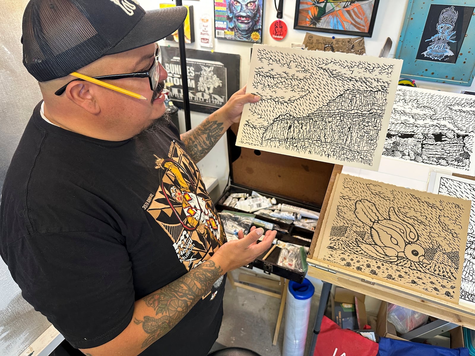 Artist Daniel McCoy talks about some of his paintings and sketches while in his studio near Española, N.M., June 13, 2025. (AP Photo/Susan Montoya Bryan)