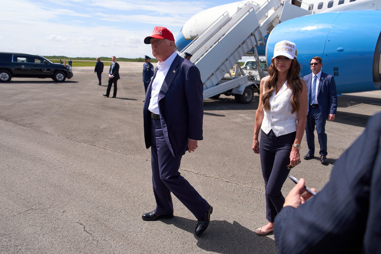 President Donald Trump and Homeland Security Secretary Kristi Noem walk off after speaking with reporters at Dade-Collier Training and Transition Airport, Tuesday, July 1, 2025, in Ochopee, Fla. (AP Photo/Evan Vucci)