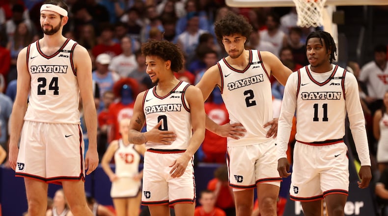 Dayton's Jacob Conner, Javon Bennett, Nate Santos and Malachi Smith wait to play against Northwestern on Saturday, Nov. 9, 2024, at UD Arena. David Jablonski/Staff