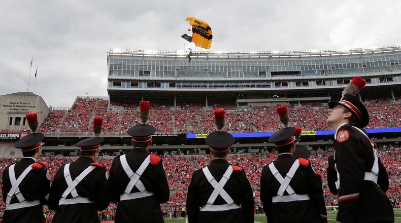 The U.S. Army Golden Knights parachute team flies into Ohio Stadium prior to a game against Ohio State at Ohio Stadium in Columbus, Ohio, on Saturday, Sept. 16, 2017. Ohio State won, 38-7. (Adam Cairns/Columbus Dispatch/TNS)