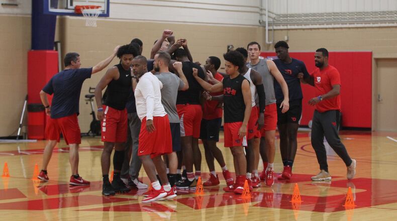 Dayton huddles b efore practice on Monday, Sept. 23, 2019, at the Cronin Center. David Jablonski/Staff