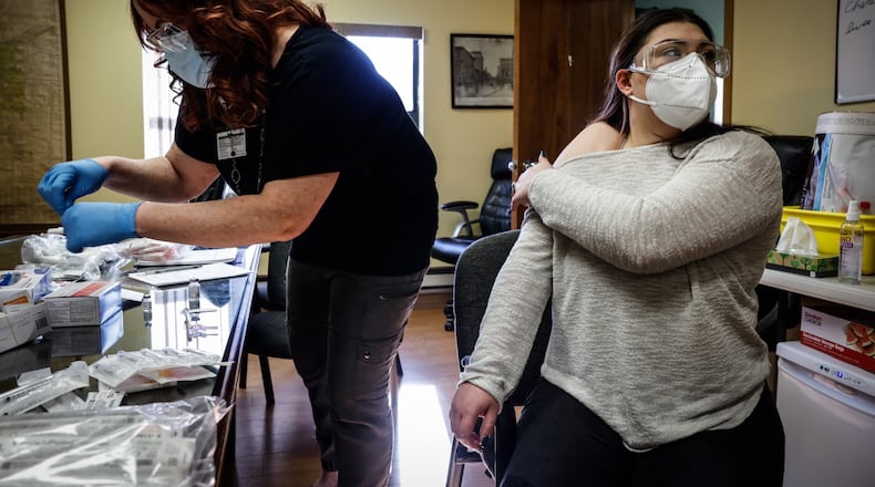 Jacinda Snider, a collaborative pharmacist distributes COVID-19 booster shots at Grafton Oaks Nursing Home on Grafton Ave. Tuesday Jan. 11, 2022. Snider volunteers long hours including evenings and weekends to give people vaccines. She has provided hundreds of Ohioans against COVID-19. JIM NOELKER/STAFF