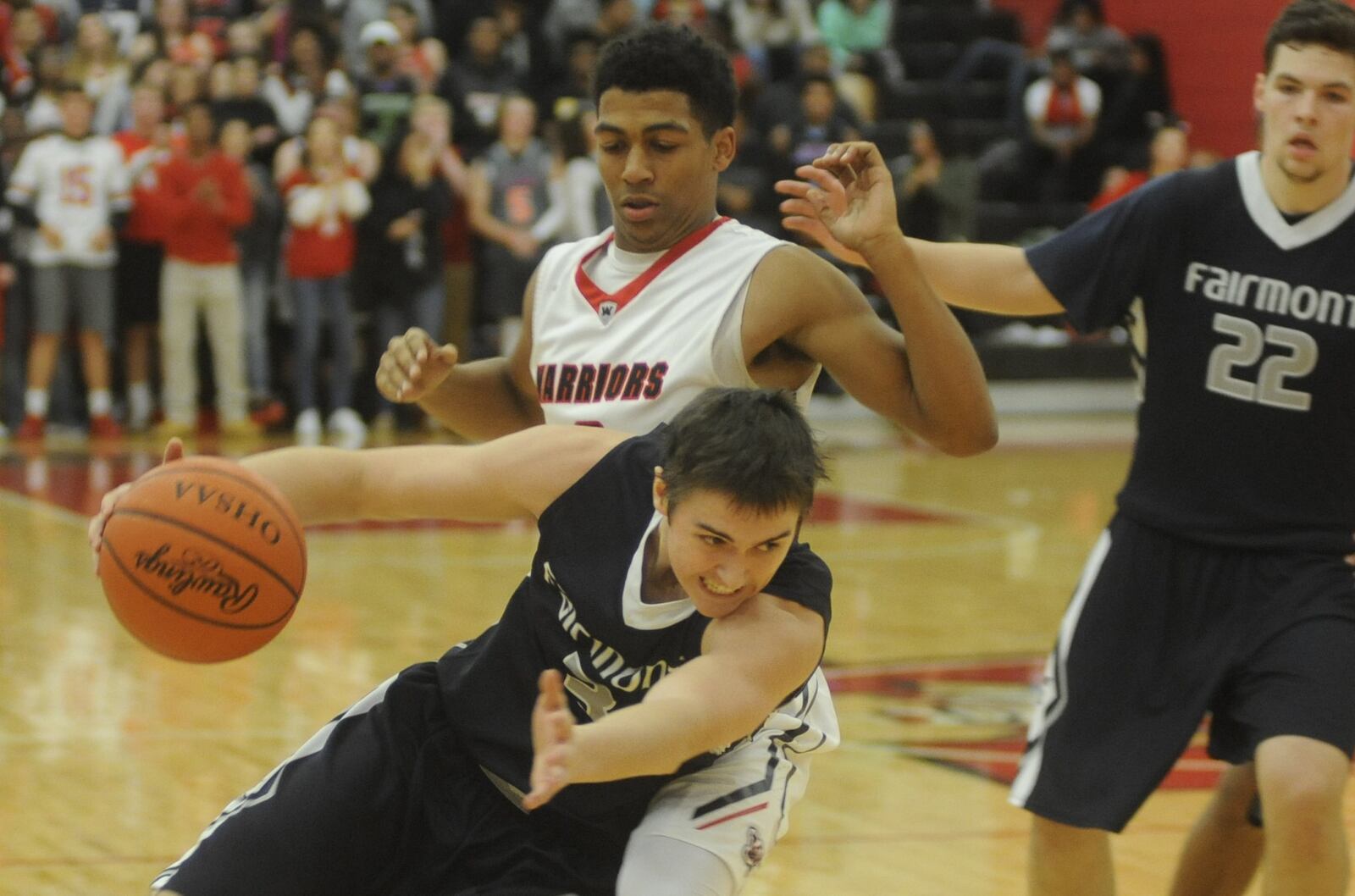 Fairmont’s Cade Morgan (with ball) is checked by Wayne’s Isaiah Trice. Wayne defeated visiting Fairmont 65-57 in a boys high school basketball season opener on Friday, Dec. 9, 2016. MARC PENDLETON / STAFF