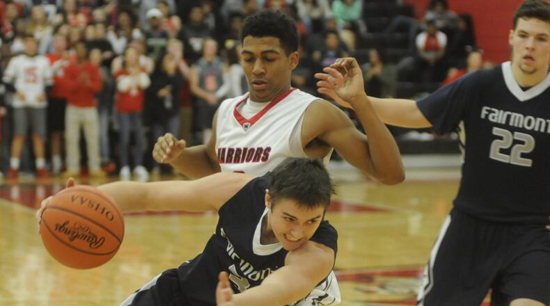 Fairmont’s Cade Morgan (with ball) is checked by Wayne’s Isaiah Trice. Wayne defeated visiting Fairmont 65-57 in a boys high school basketball season opener on Friday, Dec. 9, 2016. MARC PENDLETON / STAFF
