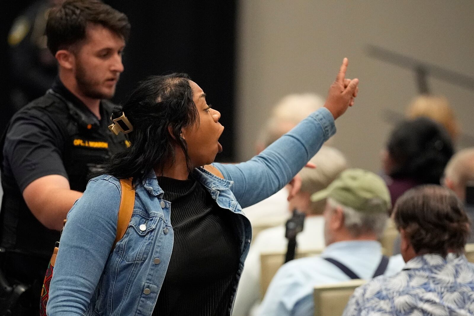 A protester is removed as Rep. Marjorie Taylor Greene, R-Ga., speaks during a town-hall style meeting, Tuesday, April 15, 2025, in Acworth, Ga. (AP Photo/Mike Stewart)