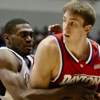 Jason Maxiell, of Cincinnati, left, defends Dayton's Sean Finn in a game in Cincinnati on Dec. 23, 2003. Lisa Powell/Staff
