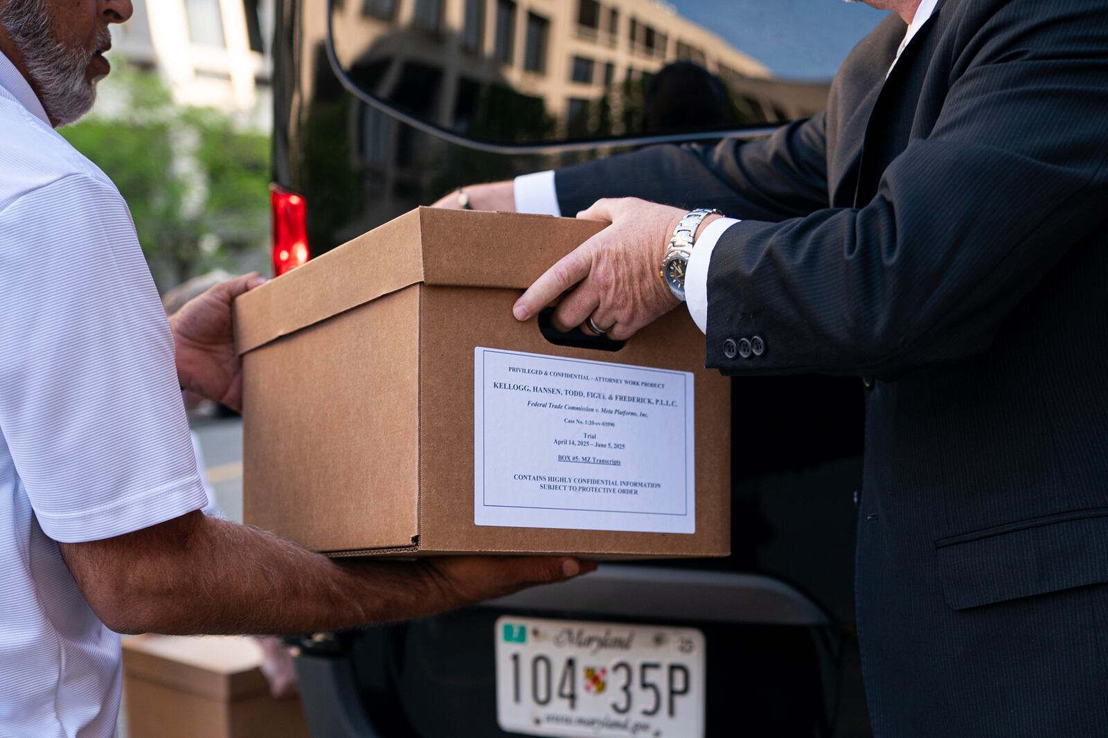 Workers load boxes of documents into a vehicle following the first day of a historic antitrust trial about Meta CEO Mark Zuckerberg's intentions in acquiring Instagram, at Barrett Prettyman United States Court House in Washington, Monday, April 14, 2025. (AP Photo/Nathan Howard)