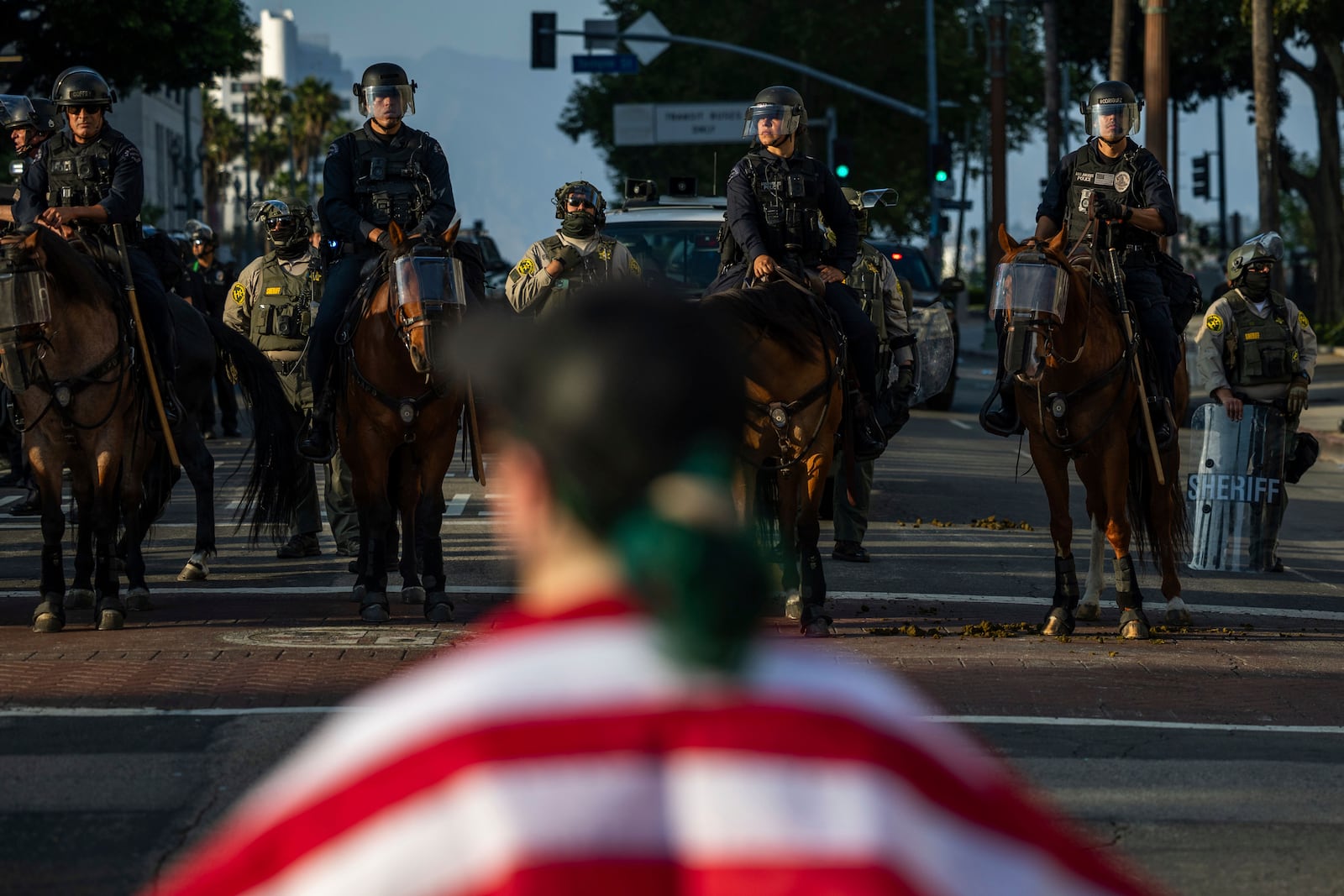 Police confront a protesters outside City Hall during protests over federal immigration enforcement raids on Wednesday, June 11, 2025, in Los Angeles. (AP Photo/Ethan Swope)