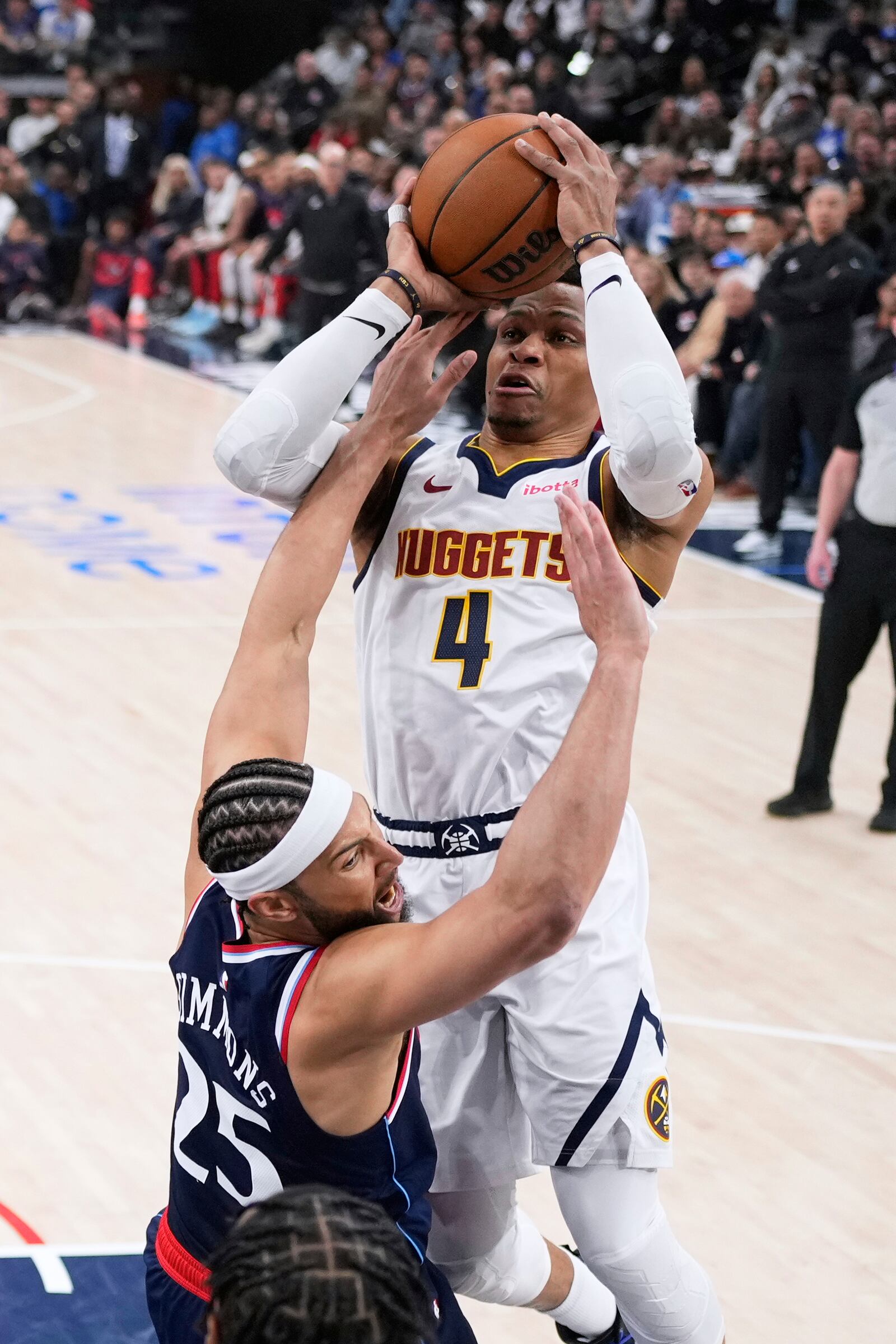 Denver Nuggets guard Russell Westbrook, top, shoots as Los Angeles Clippers guard Ben Simmons (25) defends during the first half in Game 3 of an NBA basketball first-round playoff series Thursday, April 24, 2025, in Inglewood, Calif. (AP Photo/Mark J. Terrill)