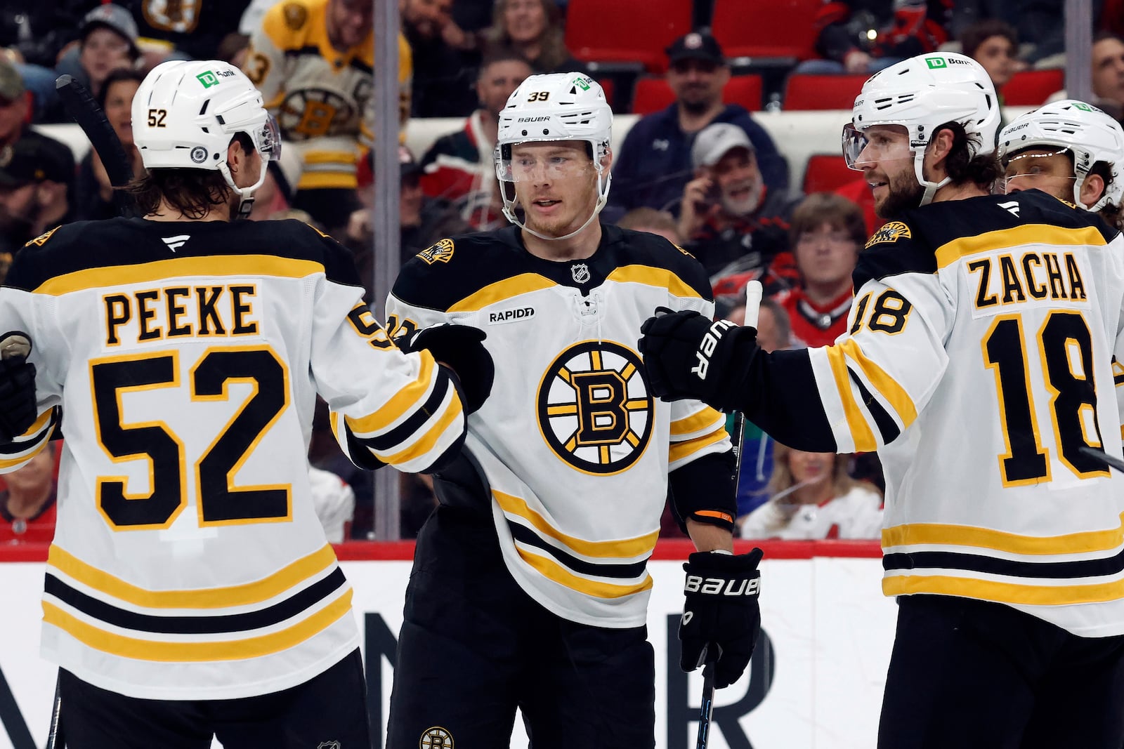 FILE - Boston Bruins' Morgan Geekie, center, celebrates after his goal with teammates during the first period of an NHL hockey game against the Carolina Hurricanes in Raleigh, N.C., March 6, 2025. (AP Photo/Karl DeBlaker, File)