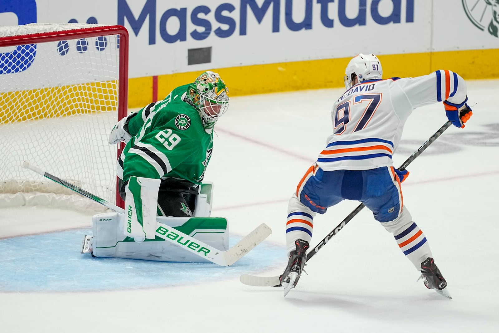 FILE - Edmonton Oilers center Connor McDavid (97) prepares to shoot against Dallas Stars goaltender Jake Oettinger (29) during overtime in Game 1 of the NHL hockey Western Conference Stanley Cup playoff finals, May 23, 2024, in Dallas. (AP Photo/Tony Gutierrez, File)
