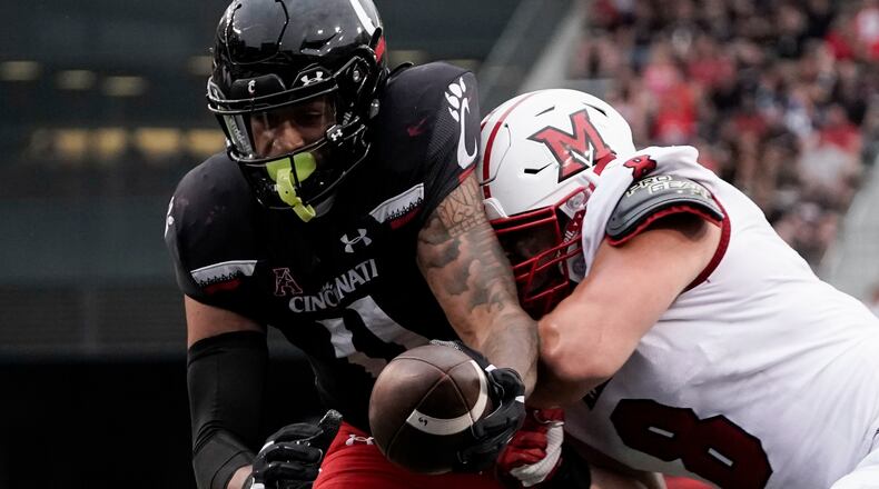 Cincinnati tight end Leonard Taylor, a Springfield High School grad, scores a touchdown during the second half of an NCAA college football game against Miami (Ohio), Saturday, Sept. 4, 2021, in Cincinnati. (AP Photo/Jeff Dean)