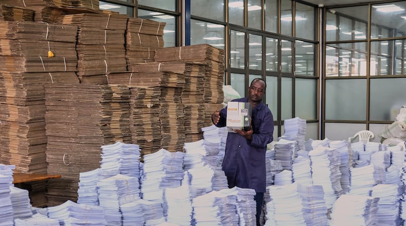 An Electoral Commission officer organises voter registrations at the Electoral Commission office in Kampala, Uganda, Wednesday, Jan. 7, 2026. (AP Photo/Hajarah Nalwadda)