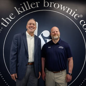 Executive director of the University of Dayton's Fastlane organization Phil Ratermann, left, and Killer Brownie Chief Operating Officer Matt Ross at Killer Brownie in Miamisburg. Fastlane assisted Killer Brownie in 2024. JIM NOELKER/STAFF